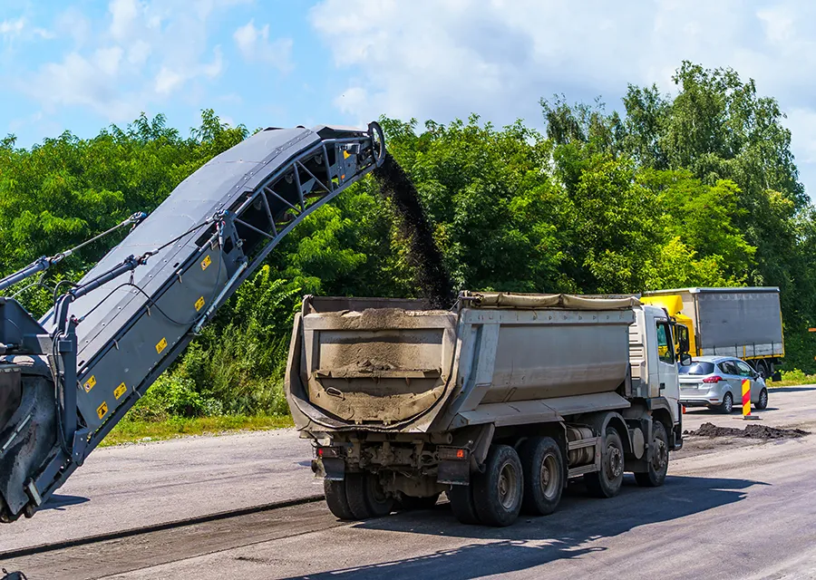 asphalt milling cold planer loading into a dump truck